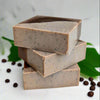 An exfoliating soap bar with the uplifting scent of coffee mixed with the sweet scent of vanilla and hazelnuts. Coffee grinds are used for exfoliation in one half of the soap bar, the other half hydrates and moisturizes with soy milk and shea butter.